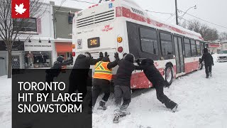 Snowstorm blankets Toronto shutting highways and closing schools [upl. by Oiziruam]