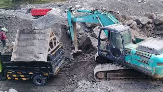 excavator working to dredge sand and load it into a dump truck  sand mining [upl. by Akirehs]