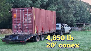 Unloading a 20 conex box off a trailer with a tractor and chain [upl. by Onirotciv]