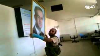 Member of the Free Syrian Army breaks portraits of the heads of the regime [upl. by Avla]