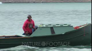 Inuit Man Driving Freighter Canoe Coronation Fiord Auyuittuq National Park Baffin Island [upl. by Russian]