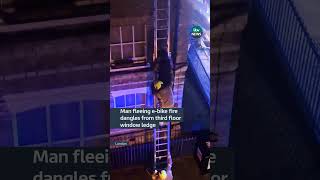 Man fleeing ebike fire dangles from third floor window ledge itvnews [upl. by Caprice]