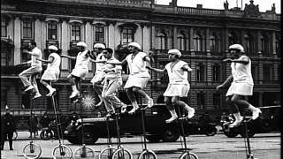 A family group of nine unicyclists perform in Berlin in front of the Brandenburg HD Stock Footage [upl. by Ado525]