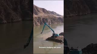 Long reach excavator dredging deep pond [upl. by Lerual]