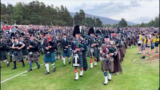 Massed Pipe Bands marching around Highland Games field during 2022 Braemar Gathering in Scotland [upl. by Nim]