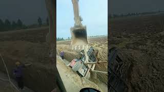 An excavator pulls a loader out of a trench [upl. by Lorant]