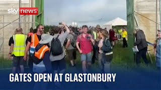 Glastonbury 2023 Festival goers pour though the gates at Worthy Farm [upl. by Gnehc]