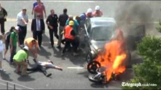 Trapped motorcyclist rescued from under burning car [upl. by Aneres508]