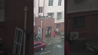 Man seen relaxing in accumulated rainwater on rooftop in Shanghai [upl. by Andrej774]