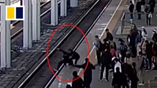 Train officer stops man from jumping onto track [upl. by Ymmas]