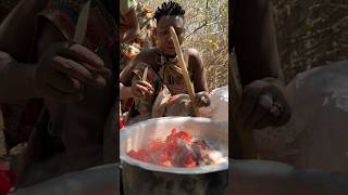 A Hadza woman skillfully prepares a meal over an open fire in the heart of the forest [upl. by Melessa]