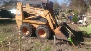 Case 1845C skid loader removing tree trunks [upl. by Alleoj]