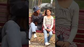 Kind woman helps little girl tie her hair shorts [upl. by Athelstan]