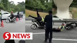 Seremban cops nab biker who rammed into JPJ officer at roadblock [upl. by Tnerual549]