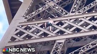 WATCH Man climbs Eiffel Tower ahead of Olympics closing ceremony [upl. by Hillard]