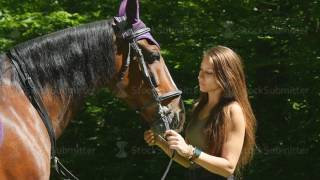 Side view horsewoman with long hair in the forest with her horse  Stock video footage [upl. by Ttergram]