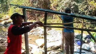 tying support poles of simple shelter in middle of the wilderness building simple shelter together [upl. by Bazil]