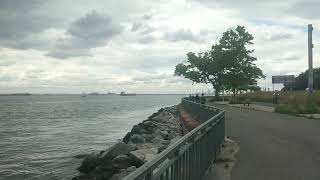 Walk along the long promenade overlooking the bridge waterfront ships cyclists and road traffic [upl. by Eimma]