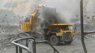 Komatsu PC3000 loads a Komatsu HD785 haul truck and kicks up dust [upl. by Anatolio]