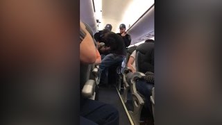 Video shows a passenger forcibly dragged off a United Airlines plane [upl. by Chesnut]