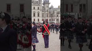 Massed Highland Pipe Bands fundraising march in front of Dunrobin Castle in Scotland shorts [upl. by Baldridge]