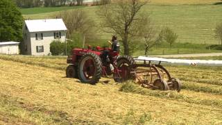 Recently restored 1943 Farmall H raking hay [upl. by Nosniv927]