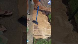 Pushing sand into patio pavers add stability and improves drainage for a stronger patio [upl. by Amak520]