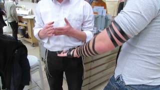 Putting on tefillin phylacteries including an explanation The Western Wall Jerusalem [upl. by Anthia879]