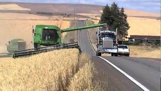 John Deere Combine Unloading On Go  Highway [upl. by Lletnuahs]