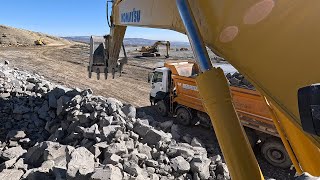 Komatsu Excavator Loading stones onto trucks [upl. by Dnivra723]