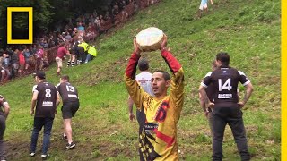 Watch a Downhill CheeseChasing Competition in Britain  National Geographic [upl. by Akcired542]