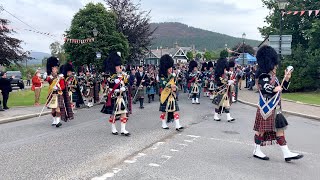 Massed Pipes and Drums marching to the 2022 Braemar Gathering Highland Games in Scotland [upl. by Nosrettap]