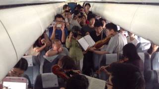 Philadelphia Orchestra musicians perform on flight waiting on Beijing tarmac [upl. by Xena]