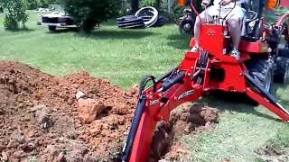 Digging trench with Massey Ferguson GC 2410 TLB [upl. by Carol]