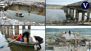 La destrucción de un puente en Járkiv obliga a los residentes ucranianos a cruzar el río en bote [upl. by Nareht]