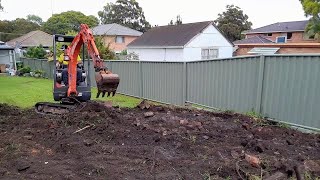 Mini Excavator excavating levelling and reshaping the yard [upl. by Enohsal]