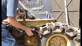 Tightening Grouser tracks on NH LS 170 skid steer [upl. by Ahsinrats873]