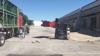 Unloading a flatbed of teardrop pallet rack pallet rack installation progress [upl. by Eillit277]