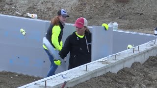 Northwestern Energy volunteers install insulation for Habitat homes [upl. by Aneerehs787]