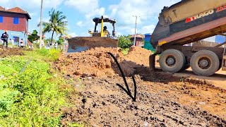 Ah so wonderfulStrong machinery dozer D41P pushing land by the huge heavy dump truck unloading it [upl. by Oicafinob285]