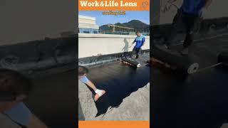 Roofers apply hot bitumen and felt layers for a durable waterproof longlasting roof [upl. by Nilkcaj]