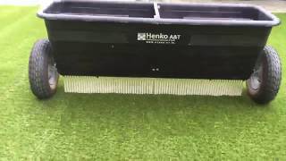 Applying sand on artificial grass during installation [upl. by Nnaihs]