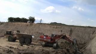 UK Coals OampK RH30D loading a fleet of Caterpillar D400 dump trucks at and opencast coal mine [upl. by Ayouqes]