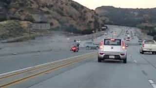 Motorcyclist kicks car causes chain reaction crash on LA freeway [upl. by Yenitsed]