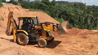 jcb 3dx transporting soil and levelling land [upl. by Ardnohsal]