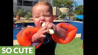 Baby attempts to eat banana while wearing floaties [upl. by Lohner]