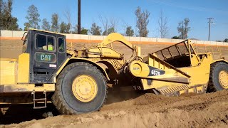 CAT 657G and 651B scrapers moving dirt  D9T Dozer ripping and pushing [upl. by Rosalba]