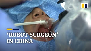 ‘Robot surgeon’ fits new teeth for dental patients in China [upl. by Bish]