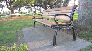 Outdoor Public Wooden Park Bench w Metal Wrought or Cast Iron Ends amp Parts  HD Stock Video Footage [upl. by Marylin]