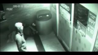 Time travelling ghost in black hoodie walks straight THROUGH closed shop door in spooky footage [upl. by Ahtamas302]